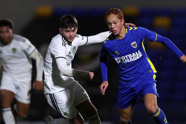 WIMBLEDON, ENGLAND - FEBRUARY 01: Ed Leach of AFC Wimbledon goes past Jay Buchan of Leeds Utd during the FA Youth Cup fourth round match between AFC Wimbledon and Leeds United at The Cherry Red Records Stadium on February 01, 2023 in Wimbledon, England. (Photo by Julian Finney/Getty Images)