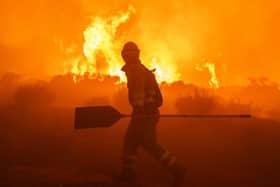 A firefighter tackling a moorland blaze. (Getty Images)