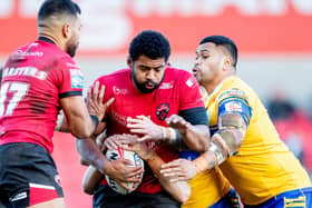 Kallum Watkins is tackled by Sam Lisone during Salford Red Devils' home loss to Leeds Rhinos in February. Picture by Allan McKenzie/SWpix.com.