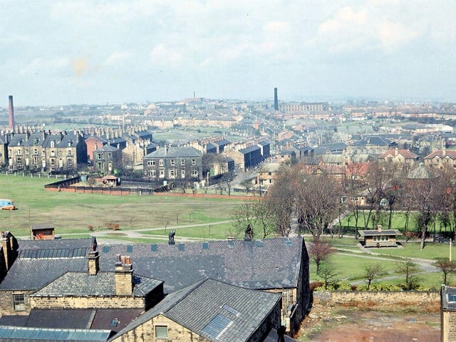 A view west from the Town Hall Tower, Morley. In the bottom left hand corner can be seen some buildings that were originally part of Albert Mills. In the centre some of the Hopkins Gardens and most of the bowling green in Scatcherd Park is visible. Scatcherd Park Avenue and the Rehoboth Chapel are seen through the trees surrounding the bowling green and a good section of Fish's Fields is visible. Brighton House and about half of Gladstone Terrace face on to the fields while behind these the remains of the New Brighton terraces can still be seen from Hilton Terrace up to Parliament Street. Dean Hall mill chimney is on the left hand side; Deanfield Mill chimney is to the right and on the horizon is that of Highfield Mills at Gildersome.