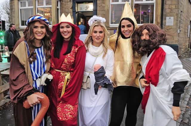 Revellers dressed as a shepherd, a wise man, Mary, a Christmas star and Jesus.