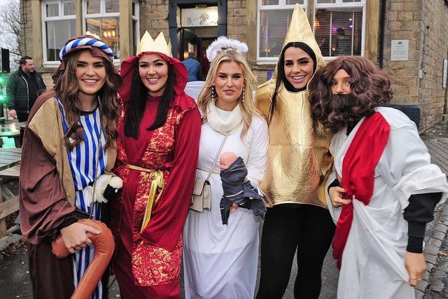 Revellers dressed as a shepherd, a wise man, Mary, a Christmas star and Jesus.