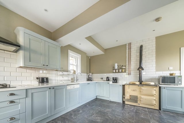 Sat to the rear is a breakfast kitchen with a range of attractive shaker-fronted units, plus a utility room with a side access door.