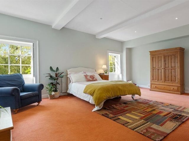 The principal suite features two large Georgian windows overlooking the front garden.