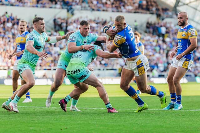 Leeds Rhinops' Mikolaj Oledzki is tackled by Matt Whitley and Morgan Knowles during the 6-0 loss to St Helens. Picture by Alex Whitehead/SWpix.com.
