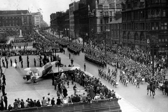 Leeds Wings For Victory week was held from June 26 to  July 3, 1943. This was a public appeal to raise a minimum of £5 million pounds to provide aeroplanes for the war effort. People were urged to invest money in National War Bonds, Savings Certificates and Bonds which would be payable in the future. This view shows crowds lining The Headrow watching a march past of combined forces and bands.