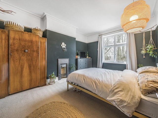 The main bedroom is above the living room and is a large, front-facing double bedroom with a lovely outlook over the woodland beyond the front garden. The bedroom has a cast-iron fire within the chimney.
