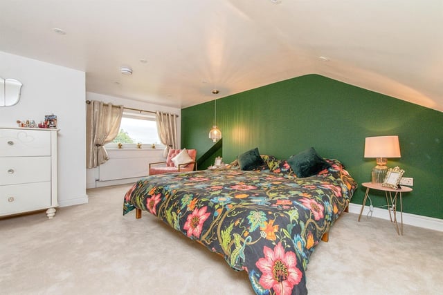 An extremely spacious, carpeted bedroom is one of four within the property.