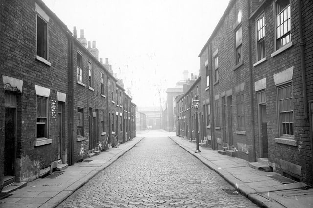 Rows of mainly derelict two storey houses with cellars in Concord Street, and looks towards the junction with Regent Street and beyond, where the next section of Concord Street continues. At the very end, across Lilac Street, works premises can be seen where Star Engineering was located in the 1950s.