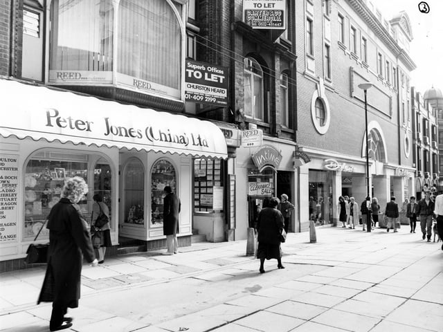 The east side of Lands Lane in Apirl 1989. Shops in focus are from left, Peter Jones China, with Reed employment agency above, In time jewellers, Dolcis footwear and Miss Selfridge ladieswear. Offices above the shops are advertised as being to let.