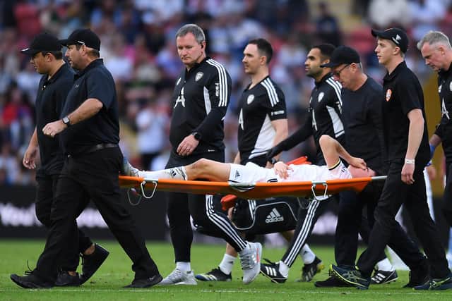 BRISBANE, AUSTRALIA - JULY 17: Archie Gray of Leeds United is stretchered off the field during the 2022 Queensland Champions Cup match between Aston Villa and Leeds United at Suncorp Stadium on July 17, 2022 in Brisbane, Australia. (Photo by Albert Perez/Getty Images)