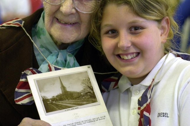 May 2002 and Morley pensioners were treated to tea to mark the Queen's Golden Jubilee in organised by Morley Community Church and served by young pupils at Cross Hall Infants  School. , Morley, Leeds. Pictured is Rose Hudson with pupil Jade Kellett.