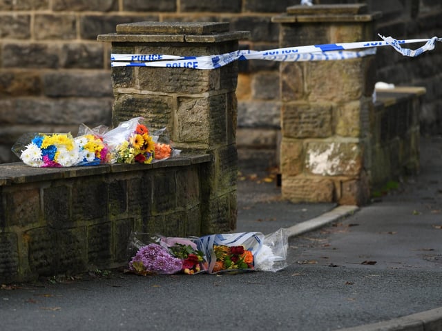 A murder investigation has been launched as people brought flowers to the junction of Church Road and Church Lane, which remains cordoned off.