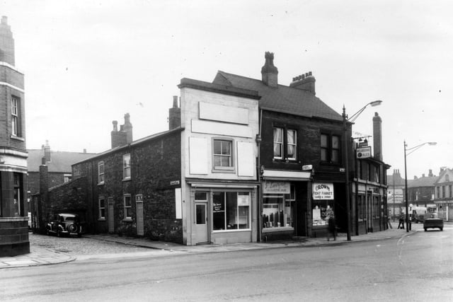 On the left of this view from June 1959 is Copley Yard where a car is parked. The two properties in view were part of the same premises as number 6 Tong Road, the pale fronted building in the centre of the view. This was an upholsterers and furnishers, business of R. Robinson. Number 4 follows to the right, this building is shared by Lilians hairdressers upstairs and G. Levine's tailors downstairs. Number 2a is the Crown Meat Market with The Crown Hotel at number 2 Wellington Road is visible on the right edge.