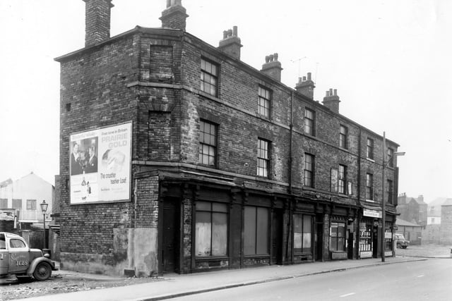 A parade of old shops in Hunslet Lane pictured in February 1961. Number 64 had been a greengrocers managed by the Sidebottom family from the late nineteenth century until the late 1950s. Number 60 is Jim's Cozy Cafe and 58 is South Market Cafe next door on the corner with South Row. The shops were scheduled for demolition in line with the Housing Act of 1957.