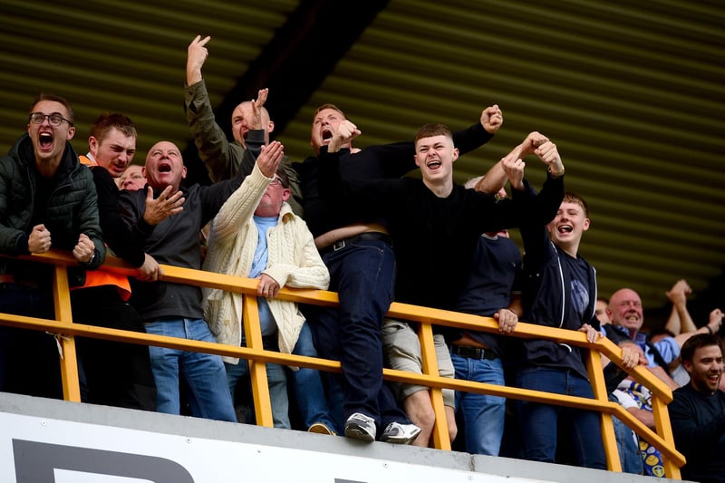 Leeds United supporters interact with their Millwall counterparts after Jack Harrison's dramatic late goal. Pic: James Hardisty