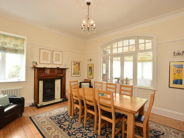 The second elegant reception room also has a fireplace and has potential to open up into the kitchen.