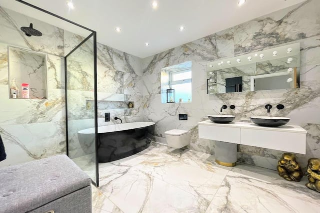 "The stunning fully tiled bathroom features a four piece contemporary suite comprising a low flush WC, freestanding bath, Jack and Jill vanity wash hand basins and a large walk in shower cubicle," says the brochure.