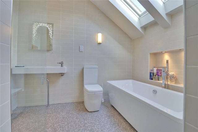 A well appointed four piece bathroom boasts a large walk-in shower, wall-hung basin, WC and a large free-standing bath tub.