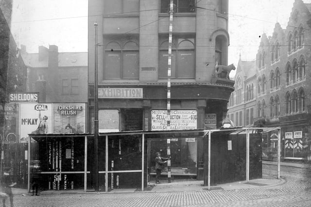 The corner of Kirkgate with New Market Street in July 1907. Former Tiger Stores on corner with statue of Tiger visible above first storey. Visible on New Market Street is J. Hepworth and sons clothiers and R. Sinclair, tobacco manufacturers.