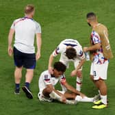 PRIDE IN DEFEAT: Leeds United's Tyler Adams is consoled by Whites club mate Brenden Aaronson and Cameron Carter-Vickers after Saturday's 3-1 loss to Netherlands in the 
Qatar World Cup. Photo by Catherine Ivill/Getty Images.
