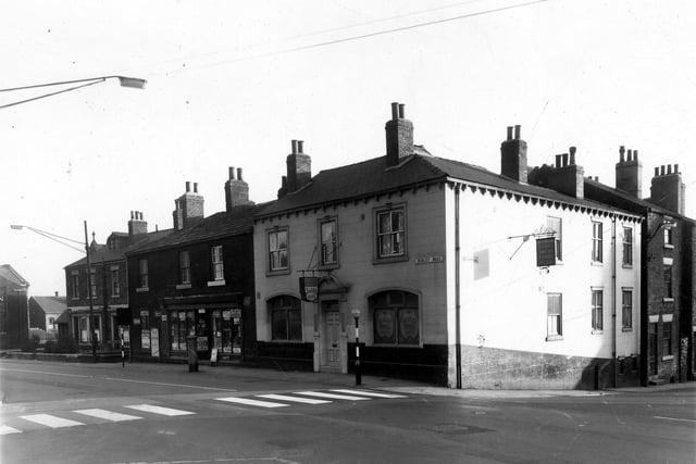 Burley Road in October 1959. From the left are two houses which are numbers 221, 223 Burley Road. This was the Sacred Hearts Parish Men's Club, the Catholic Church is back from the building line on the left. The Post Office was number 227. The public house at the corner with Willow Road is the Burley Hotel. The zebra crossing allowed children to cross Burley Road in safety to reach Burley Lawn School.