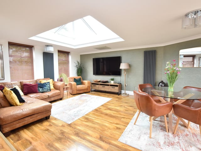 The kitchen has a square arch and steps down to the stunning living room which has two windows to the front and French doors to the rear. This welcoming room also has a large ceiling lantern light window which gives a lovely contemporary feel.