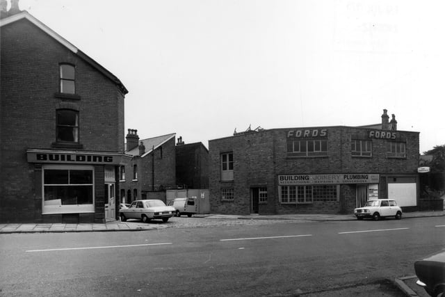 Burley Road showing the junction with Cross Greenhow Avenue in the centre in July 1975. To the right of the junction is the business of T. & L. Ford, builders. plumbers and joiners. Next to this on the far right William Hill's betting office appears to be closed up. To the left of the junction is another building with the Ford name on, possibly vacated as they moved to larger premises.