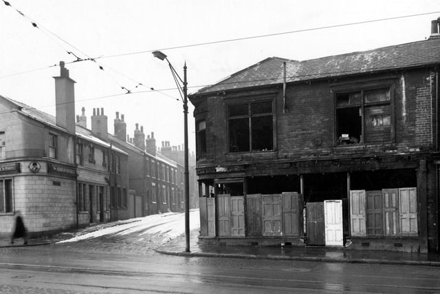 Wellington Road in February 1956 showing the junction with Ducie Street with burnt out building on right. Albion Hotel, Tetley pub on left corner.