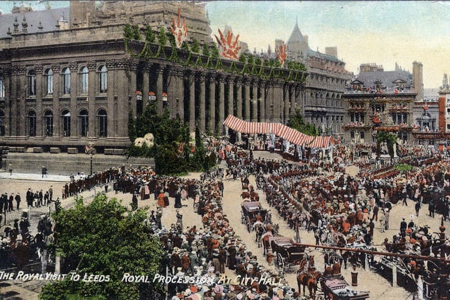 A colour-tinted postcard showing the Royal procession approaching the Town Hall (named City Hall on the postcard), during the visit.