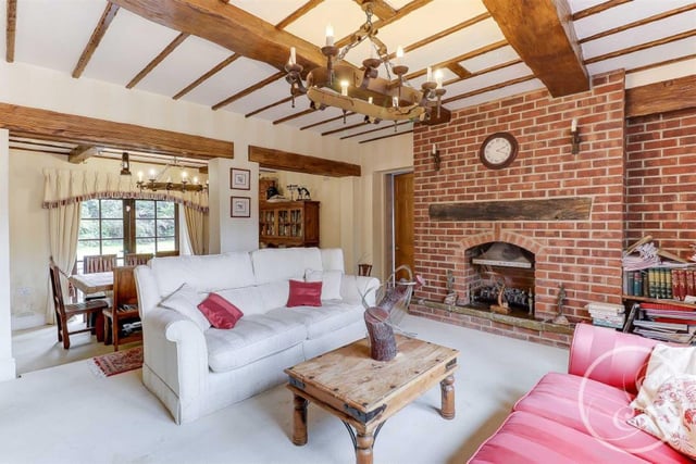 Double doors lead to the family room. This generous sized room comprises a feature fireplace and stunning wooden beams that are very in keeping with the style of the property.