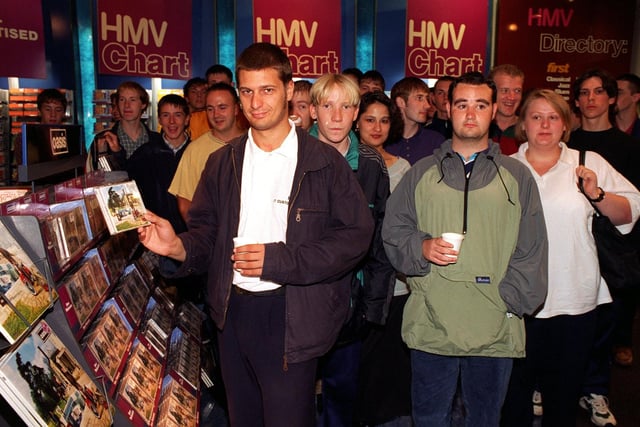 Oasis fans wait to buy the band's new album at HMV on Lands Lane.