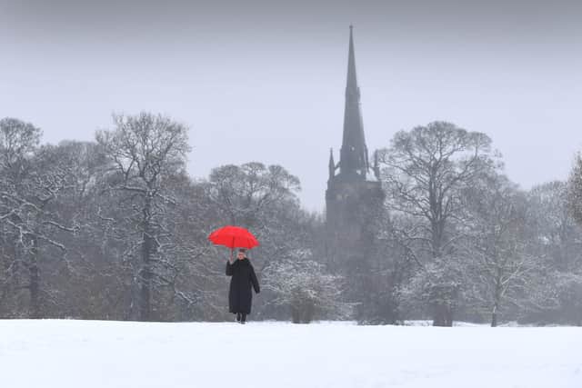 White-Out.. A lady walks through the Heavy Snow with Oulton Parish Church, Leeds as a backdrop..2nd February2021..Picture by Simon Hulme 
