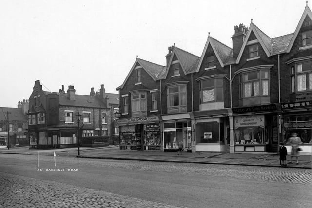 Harehills Road in September 1950.View of numbers 131 to 143  looking north east along the east side. At the far left is Ashton Grove then shop numbers 131, S. Hartshorne, Confectioner and number 133, A. Lyon, Milliner. Next is Ashton Place followed by a parade of shops numbered as 135 to 143 Harehills Road. Number 135 is J.C. Richmond, Chemist, 137 is Turner and Fishburn, Drapers. Number 139 is empty and number 141 is Leicester Shoe Repairs. Finally at number 143 there is F. and C. Eamonson, Butchers. A bus stop is visible.