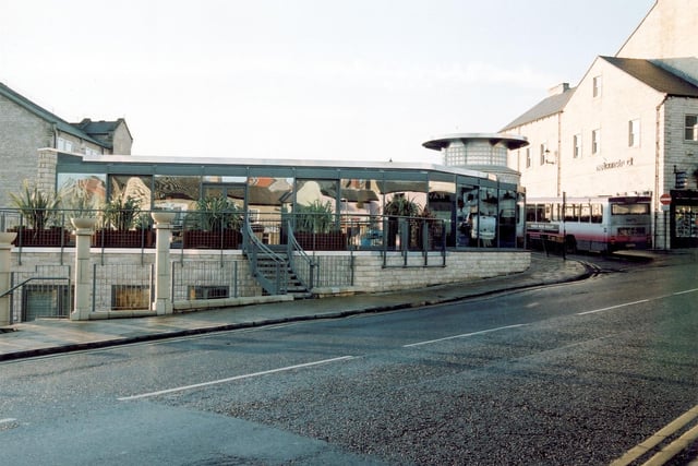 The end of Wetherby Bridge, to the right is a cafe. This was the site of a corn mill, the bus station is behind. Pictured in 2003.