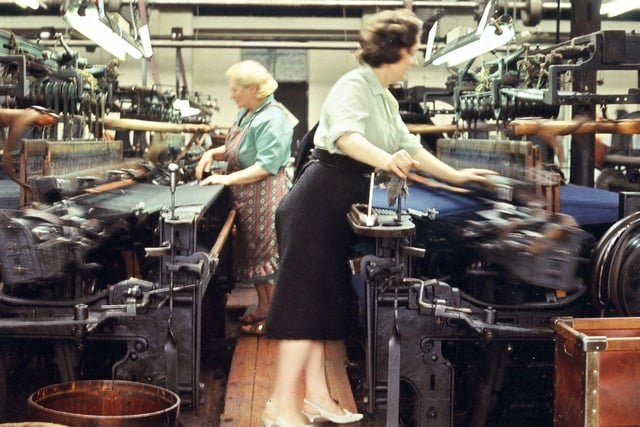 Plain looms, made by Lee and Crabtree, being used by female workers to weave ladies' overcoating material at J. & S. Rhodes' Prospect Mills. Normally looms are on the ground floor in textile mills due to the weight of the machinery or may be housed in a special weaving shed. Pictured in June 1965.