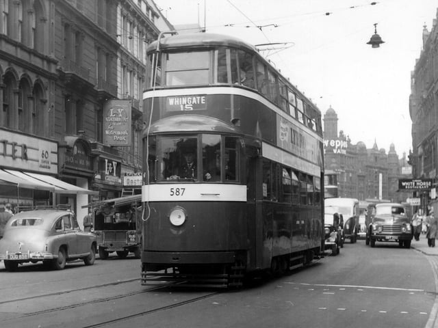 Looking east along Boar Lane in September 1955 showing tram no.587 on route 15 to Whingate. Shops on the left include Elster Shoes, the White Rose Milk Bar, Lancashire & Yorkshire Stationery Co. Ltd. and Spinks restaurant, while among those on the right is Fairburn's White Horse restaurant.