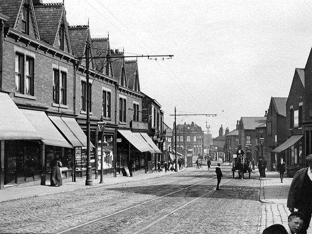 Tong Road from a postcard with a date of May 19, 1910 written on the back. Shops are seen on both sides of the road, many with awnings over the windows.