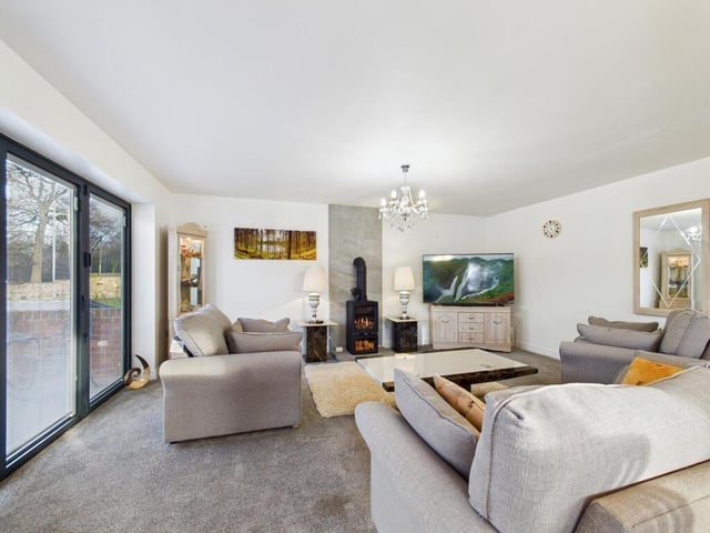 The living room has a feature log effect buying gas fire, underfloor heating and gives access to a front balcony through bi-folding doors.