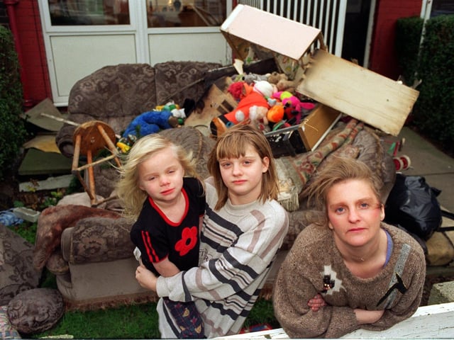 Tonia Young and children Melissa and Jodi outside their fire damaged home in Belle Isle in December 1997.