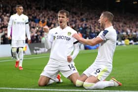 LEEDS, ENGLAND - OCTOBER 02: Diego Llorente celebrates with teammate Liam Cooper of Leeds United after scoring their team's first goal during the Premier League match between Leeds United and Watford at Elland Road on October 02, 2021 in Leeds, England. (Photo by Alex Pantling/Getty Images)