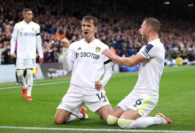 LEEDS, ENGLAND - OCTOBER 02: Diego Llorente celebrates with teammate Liam Cooper of Leeds United after scoring their team's first goal during the Premier League match between Leeds United and Watford at Elland Road on October 02, 2021 in Leeds, England. (Photo by Alex Pantling/Getty Images)