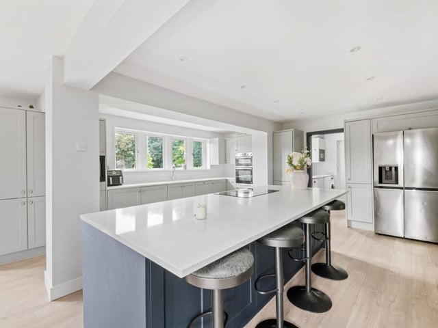 The sleek kitchen has integrated appliances.