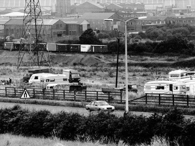 Caravans and trailers from the gypsy and traveller community. The roadside site at Stourton is located near railway wagons containing chemicals. Pictured in August 1991.
