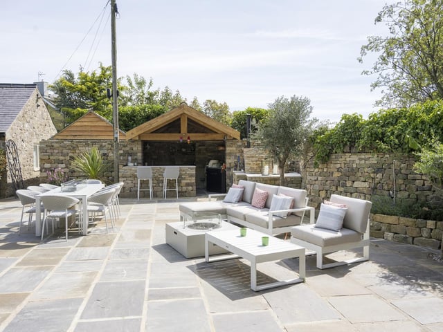 With landscaped gardens are several seating areas, and there's an outdoor kitchen.