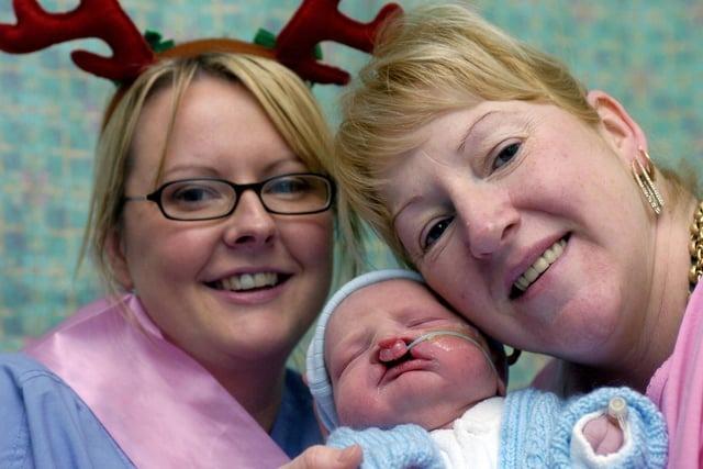 Midwife Nicola Kelly, at the Leeds General Infirmary, who delivered her first Christmas baby at 0.08am in the early hours of Christmas Day morning, pictured with baby boy Liam Brailsford, who weighs in at 8lbs 1oz, and proud mum Yvonne.