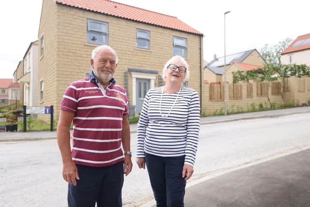 Doug and Polly outside their new home
