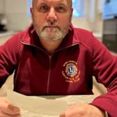 Garforth & District Lions Vice President Mark Dobson collecting the payment of £300
