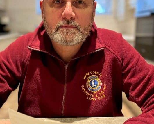 Garforth & District Lions Vice President Mark Dobson collecting the payment of £300
