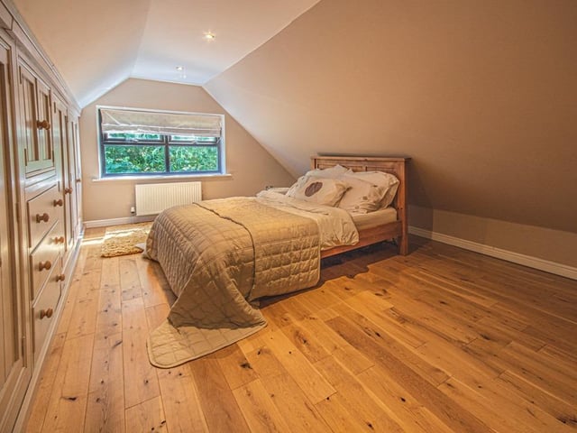 This bedroom has fitted furnishing along one of its walls.